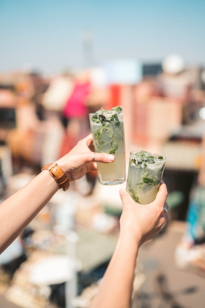 Person Holding Two refreshing Drinking Glass