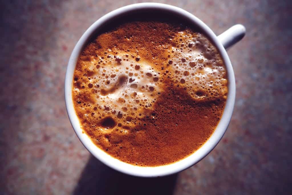 A close-up view of a gourmet cappuccino with frothy foam, perfect for coffee lovers.