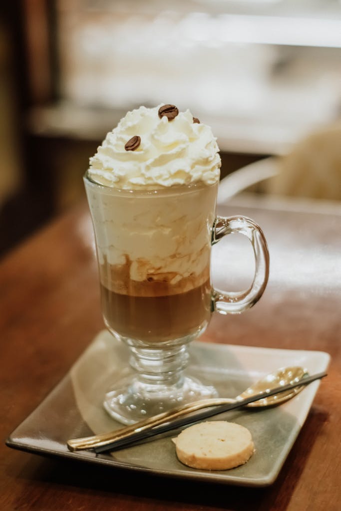 Luxurious mocha topped with whipped cream and coffee beans on a wooden table.